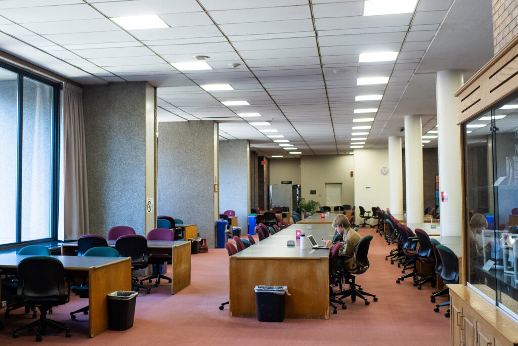 A student studies in an empty Mugar Library.