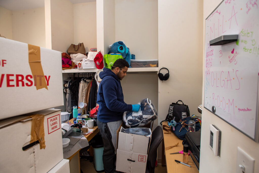 A photo of a mover in a students dorm room on the Fenway Campus.