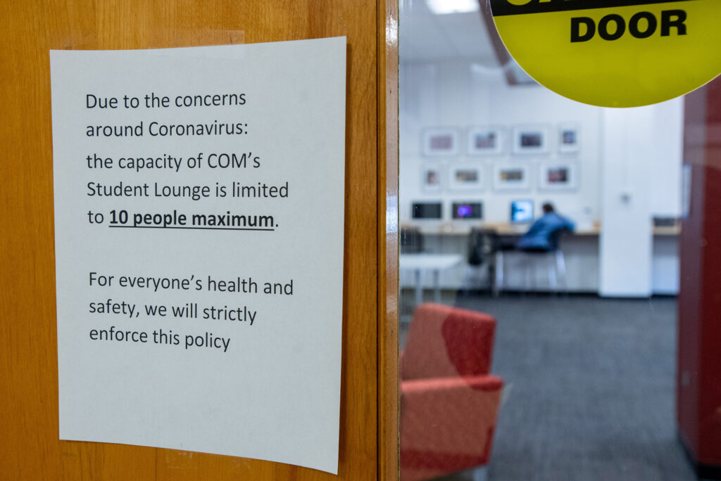 A sign posted outside the College of Communication student lounge noting that the capacity is 10 people
