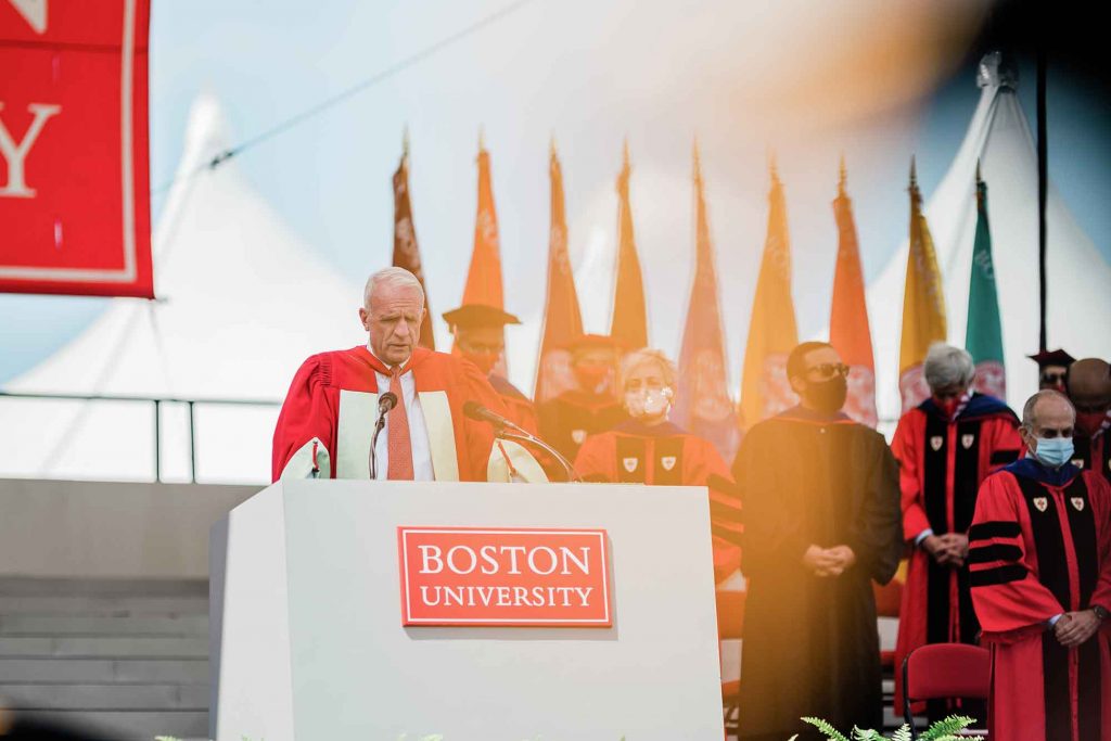 Dean of Marsh Chapel Robert Hill speaks at the podium during the Boston University Commencement for undergraduate degree students.