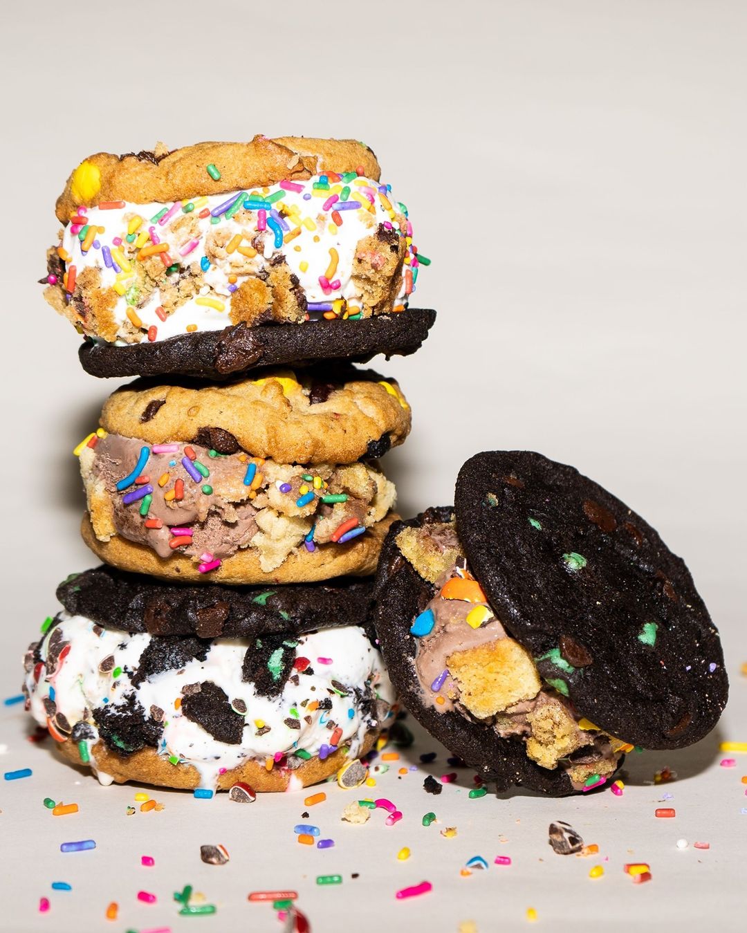 Display photo of a stack of sprinkled monsterwich cookie ice cream sandwiches from Insomnia Cookies.