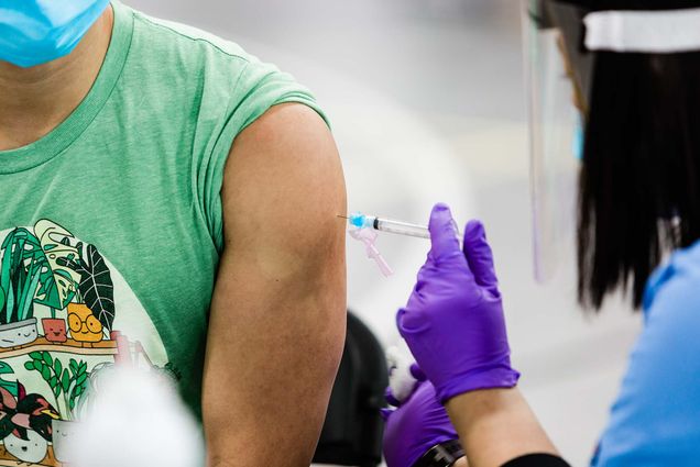 zoomed in photo of a student's arm receiving the Covid-19 vaccine at a BU clinic in January