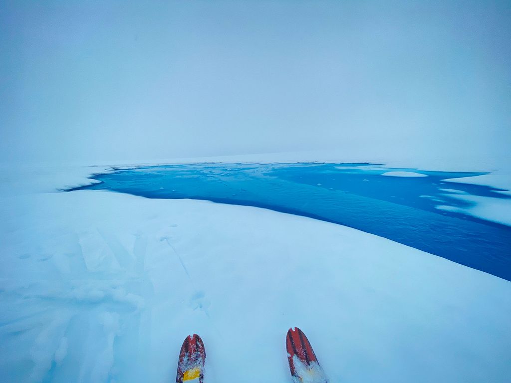 photo of a lake where one of several glacial lakes Randall and the JIRP crew came across on the glaciers, all varying in size and depth, and some lakes even had icebergs in them.