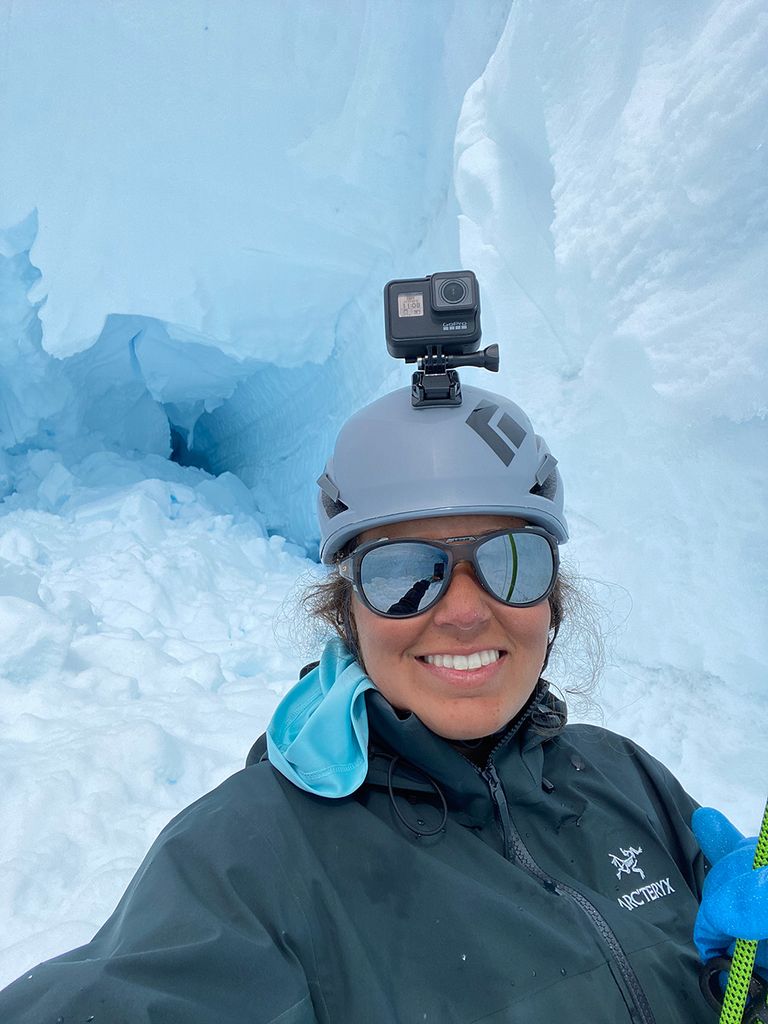 Selfie photo of Randall in a crevasse on the Vaughan Lewis Glacier (different from the Little Vaughan Lewis Glacier) near Camp 18, another field camp for JIRP. The space behind Randall is filled in with snow that fell from a collapsed ice bridge that covered the space