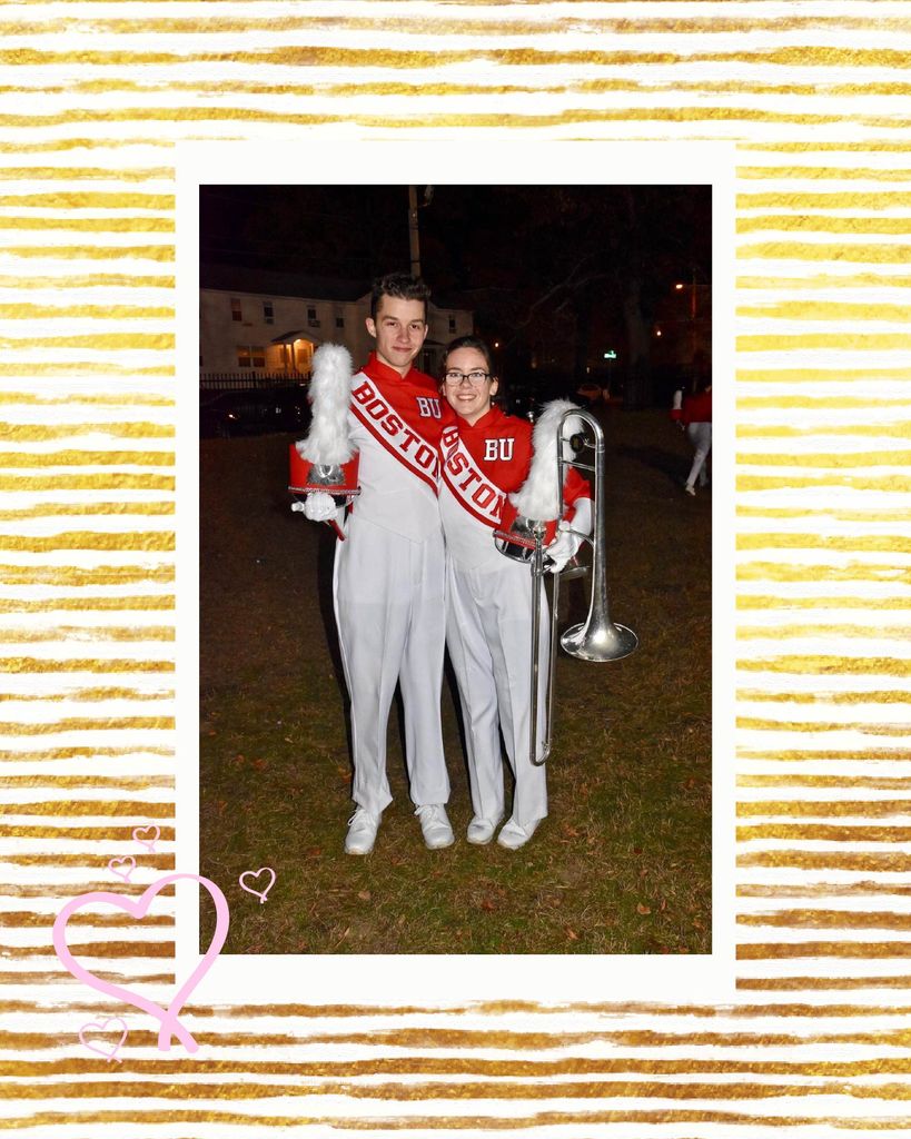 Photo of Samantha Casey (CAS’21), holding a trombone, and her partner in their BU marching band uniforms. The photo is overlaid on a white and gold striped background and a few pink hearts are drawn over the background and photo.