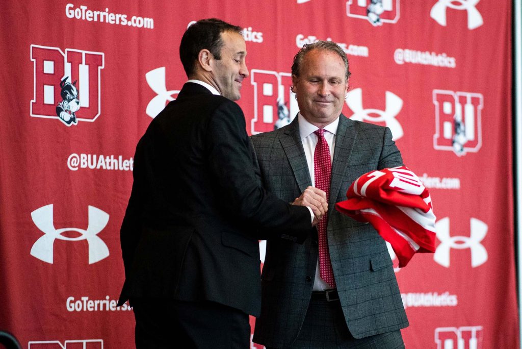 Drew Marrochello, University athletics director (right), presents Jay Pandolfo with a BU men’s hockey jersey with the number Pandolfo wore as a Terrier—17.