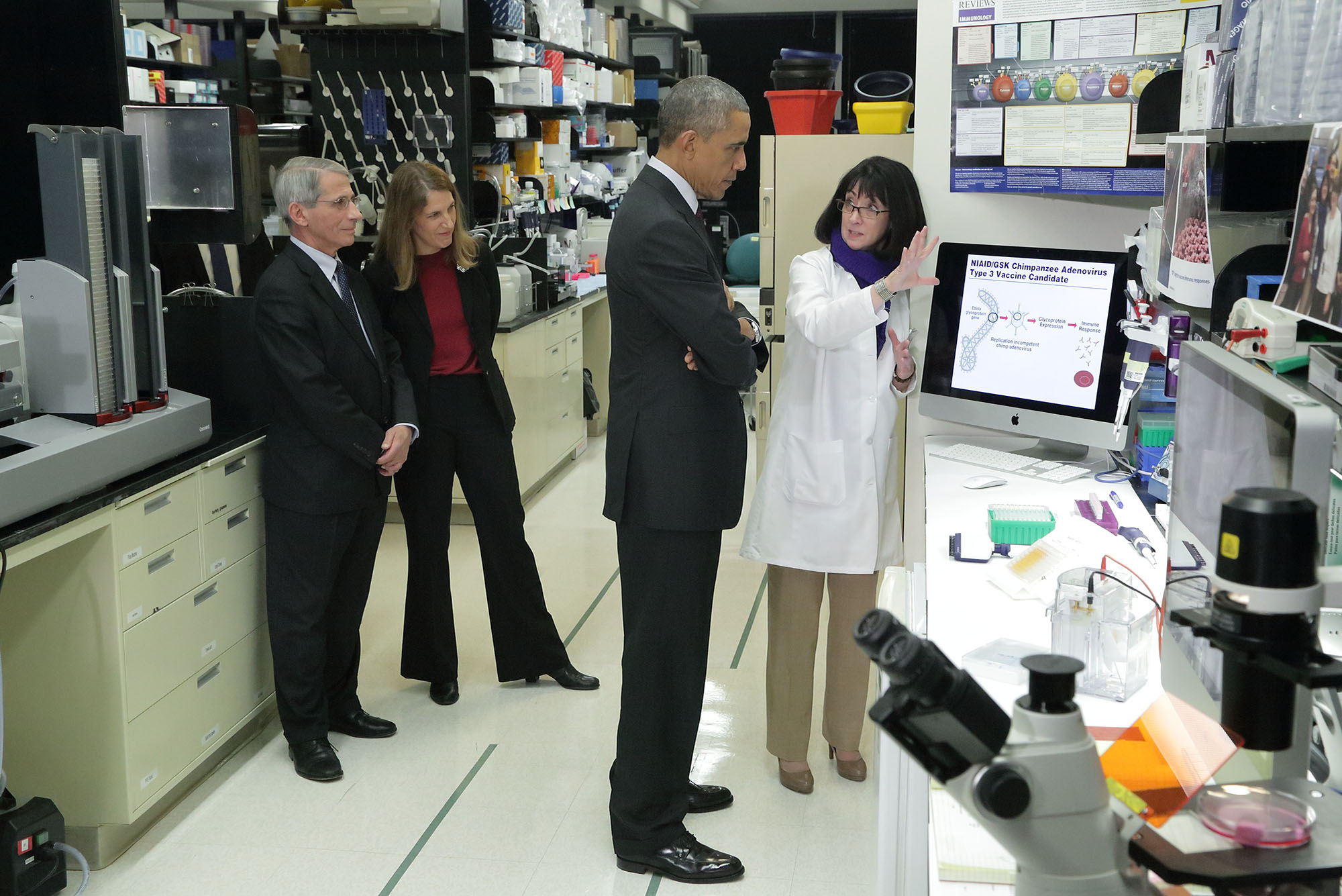 Photo of Dr. Nancy Sullivan of NIH’s National Institute of Allergy and Infectious Diseases discussing Ebola research with President Barack Obama as NIAID Director Dr. Anthony Fauci and HHS Secretary Sylvia Burwell look on.
