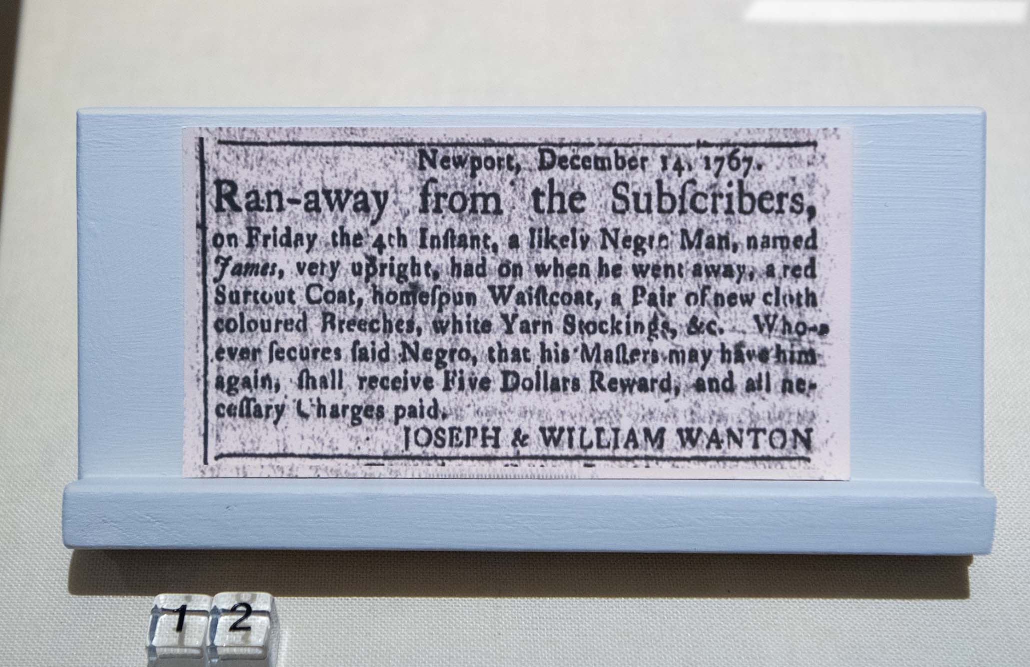 Photo: A framed runaway slave ad from the house. In large black text, the ad starts 