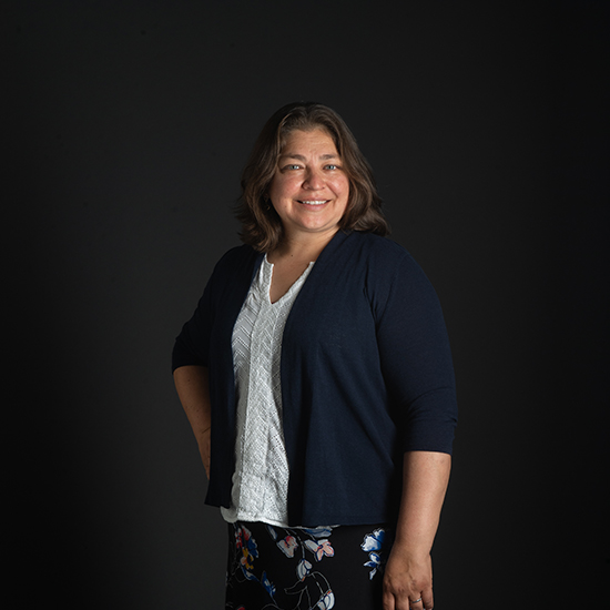 a photo of SPH associate professor Patricia Fabian as she poses in front of a black backdrop.