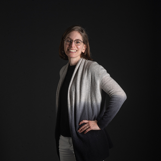 a photo of SPH assistant professor Jessica Leibler as she poses with hands on hips in front a black backdrop.