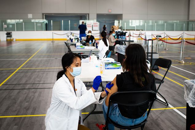 BU Medical student, Molly Jia Yong Zhao gives a flu shot to a patient during a clinic on September 29, 2020 Photo by Jackie Ricciardi for Boston University