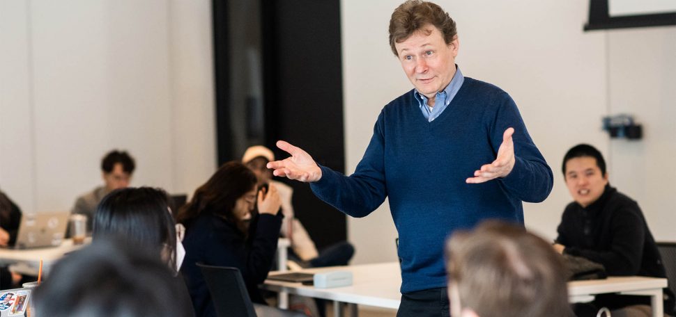 Professor Wesley Wildman, a tall white man in a blue collared shirt, teaches a Data and Ethics class at CDS on Tuesday, February 14, 2023. Photo by Jackie Ricciardi for Boston University