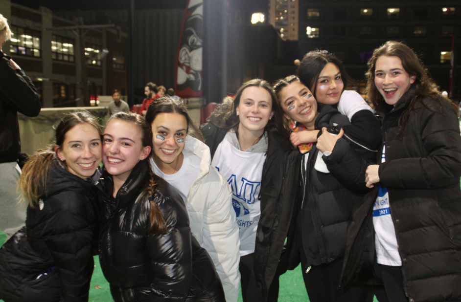 Senior Kelsey Martirano (COM'23), is pictured with six of her friends on a field after a sports game. They are smiling and closely embraced.
Picture credit: Kelsey Martirano (COM'23)