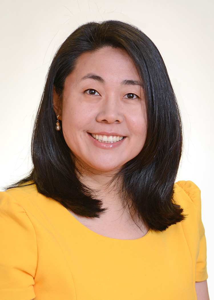 Photo: Headshot of BU epidemiologist Shanshan Sheehy. An Asian woman with shoulder length black hair hair and wearing a yellow blouse, smiles and poses for the camera in front of a white background.