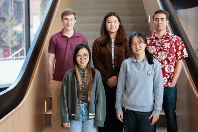 Photo: Students stand and pose for a photo at the bottom of a set of stairs. From right to left, top to bottom: Daniel Skahill (CDS ‘23), Samantha Chen (CDS ‘23), Zining Ye (CDS ‘23), Yile Wang (CDS ‘23), and Edward Wong (CDS ‘23).