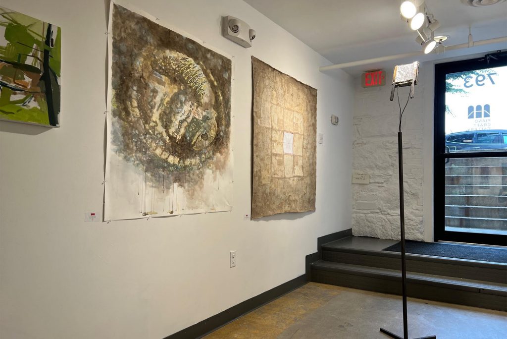 Photo: Multiple art canvases with abstract shapes on them hanging on a white wall