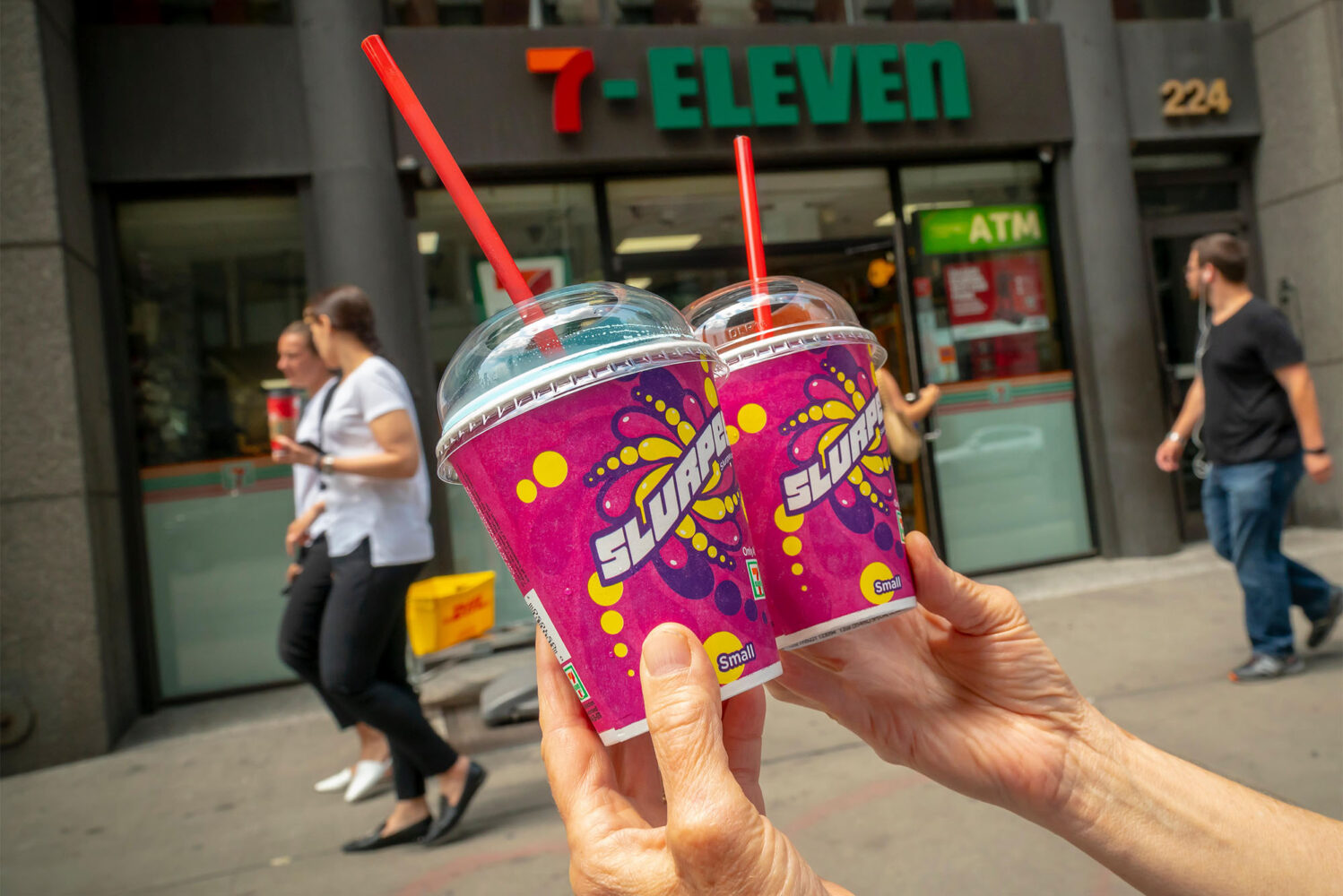 Photo: A Slurpee lover displays her Slurpees outside a 7-Eleven store in New York