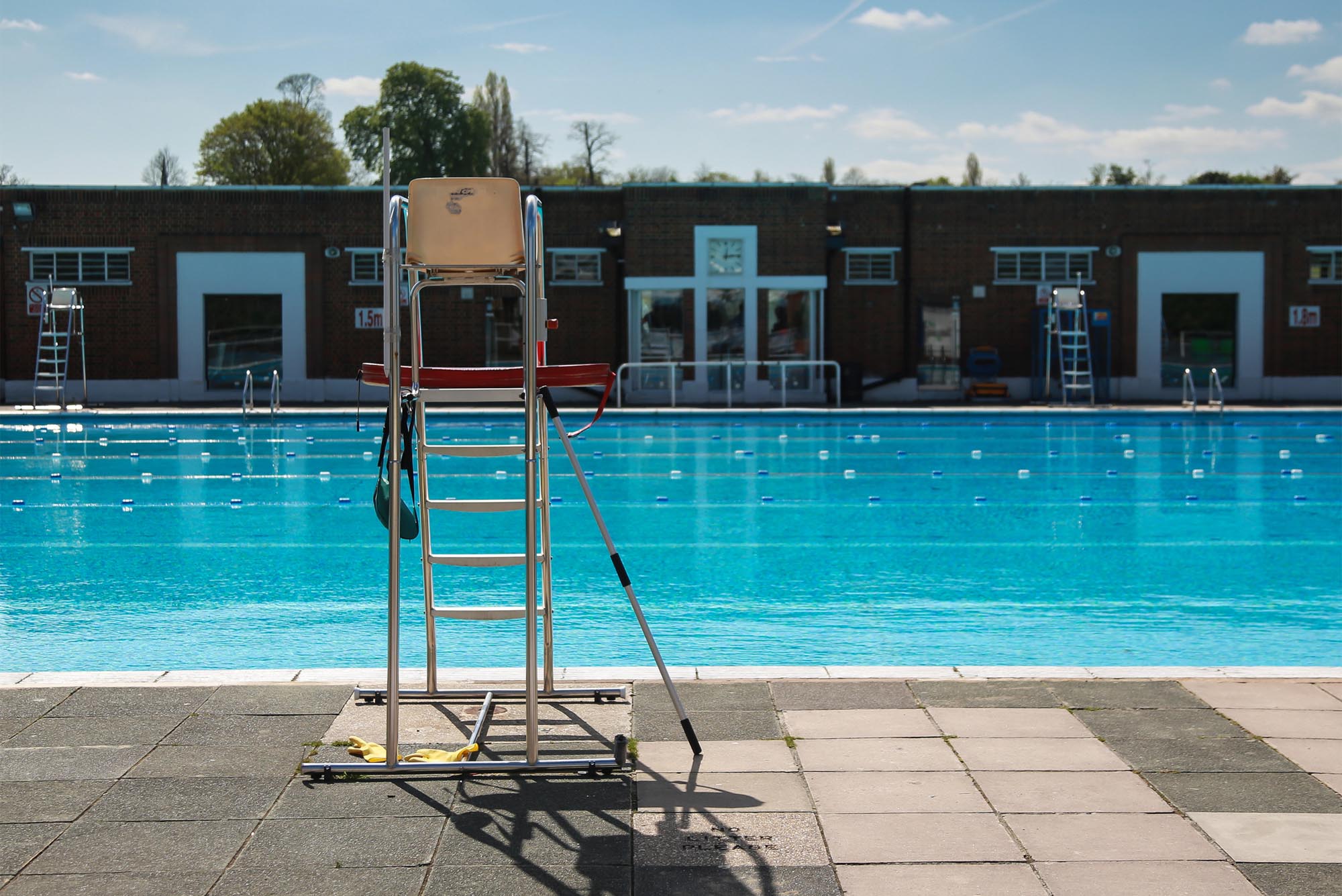 Photo: outside swimming pool with lifeguard chair in foreground