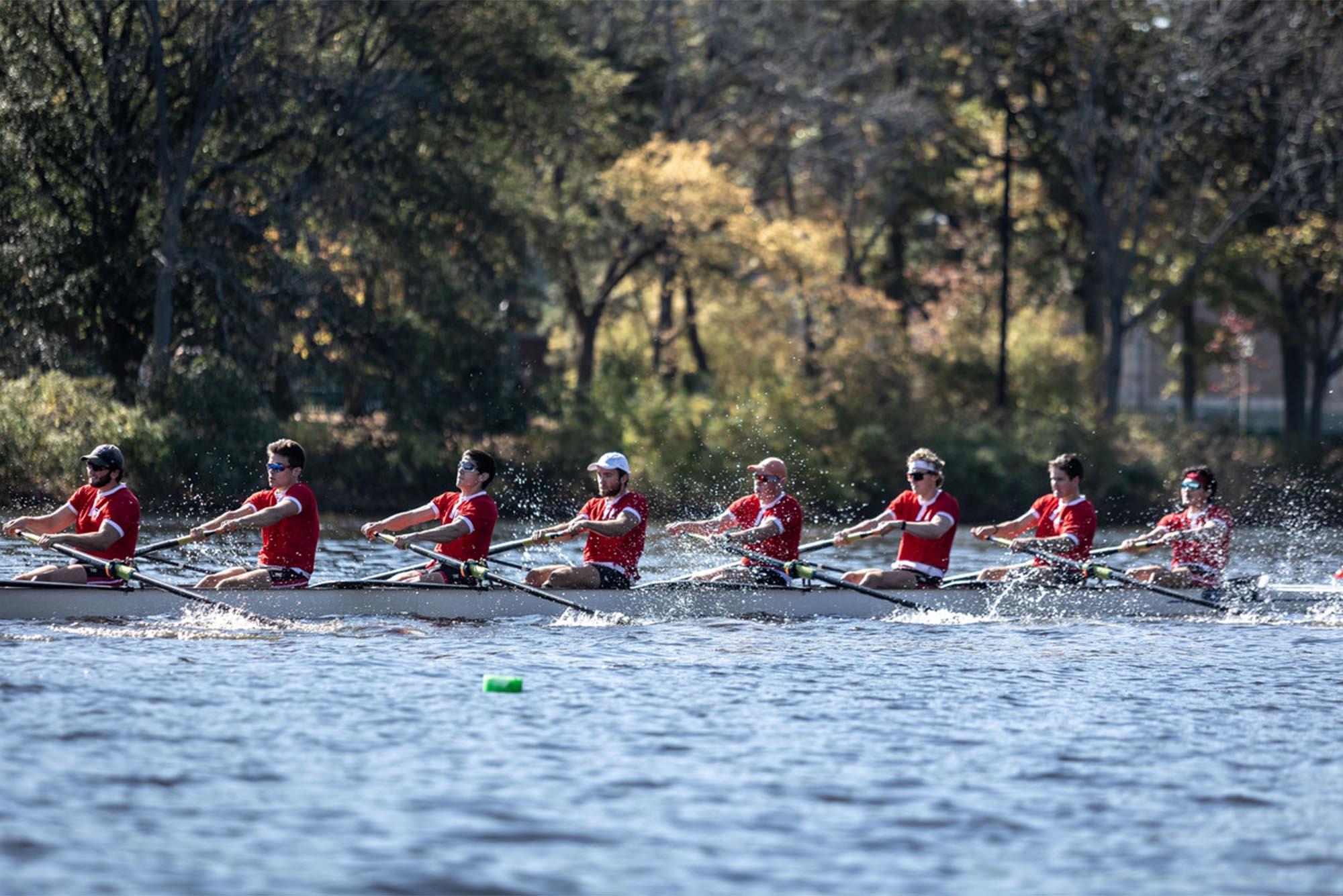 Photo: A group of rowers work hard to move their boat down the Charles river