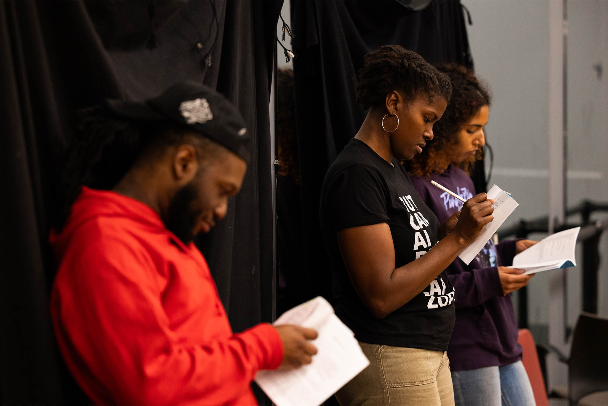 Photo: College theatre students taking notes at a rehearsal