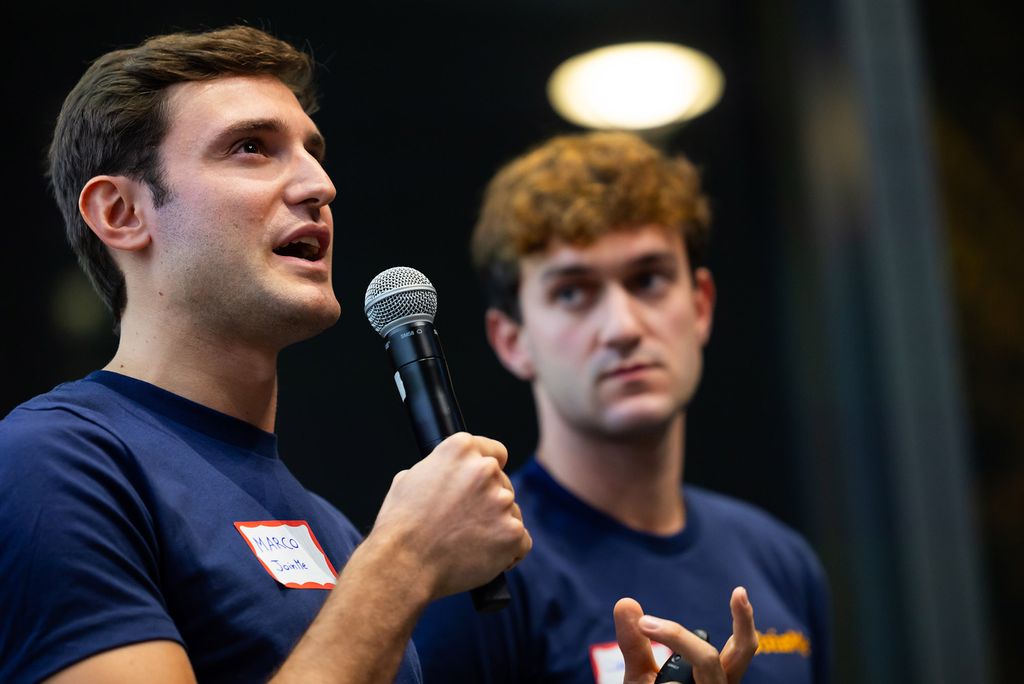 Photo: Marco Rosella, (Questrom’22) (left) and Claudio Bettini (COM’23) speak to the crowd as they pitch their invention, JoinMe.