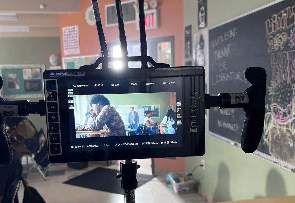 Photo: The screen of a large camera is shown as it records a classroom scene for the movie.