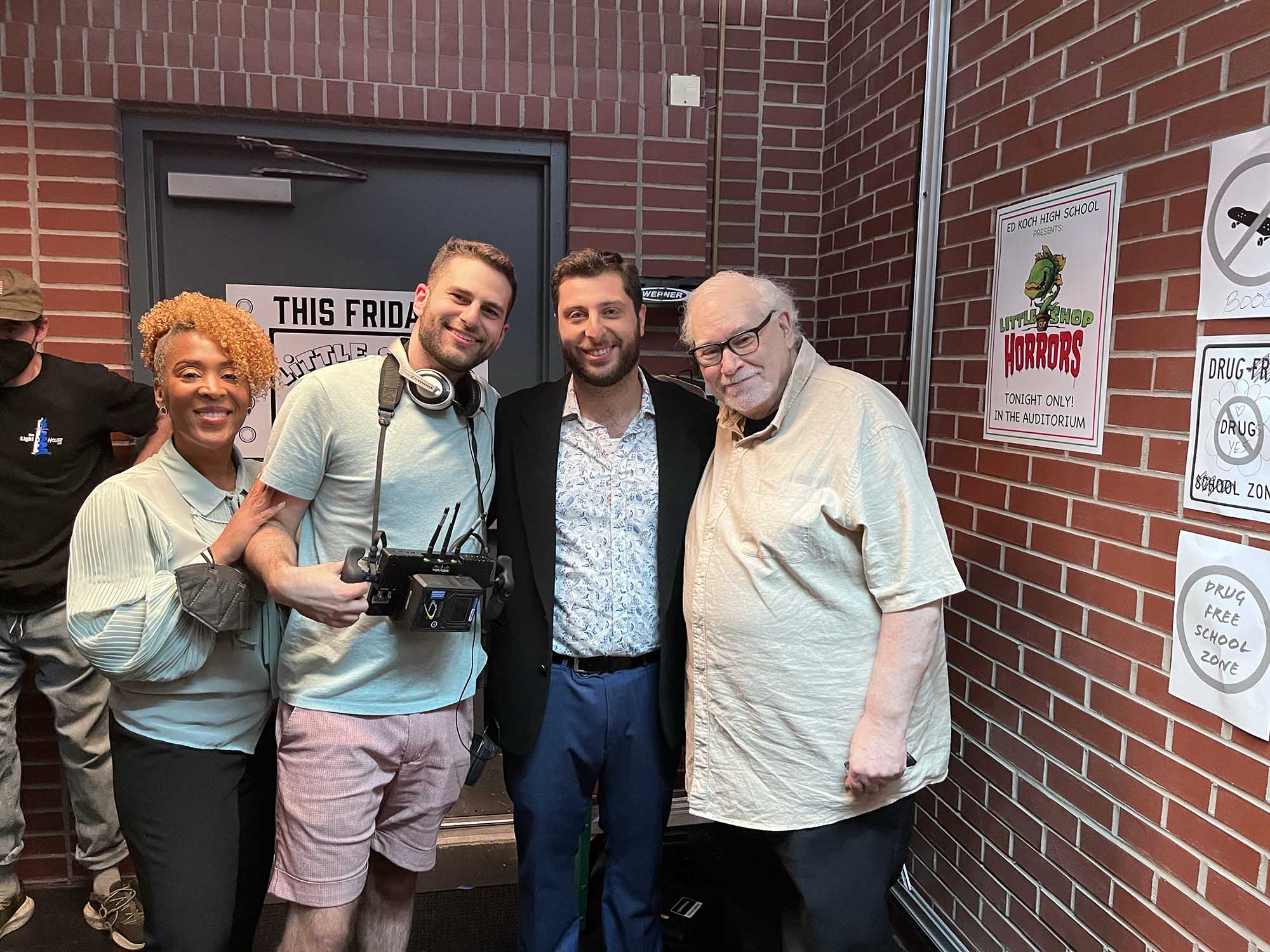 Photo: Four people pose for a photo in front of a brick building. Actor Lisa Anne Loggins (from left), film director Amnon Carmi, screenwriter, producer, and star Ben Ducoff, and actor Mitchell Fields on set.