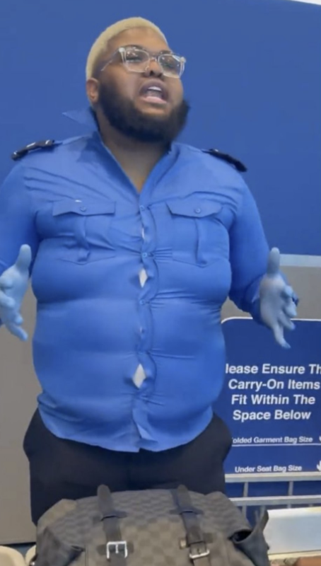 Photo courtesty of @teefortilly on Twitter (X). This is a screenshot from a comedian's skit pretending to be a TSA employee. He is wearing a TSA uniform that's extremely small on him. 