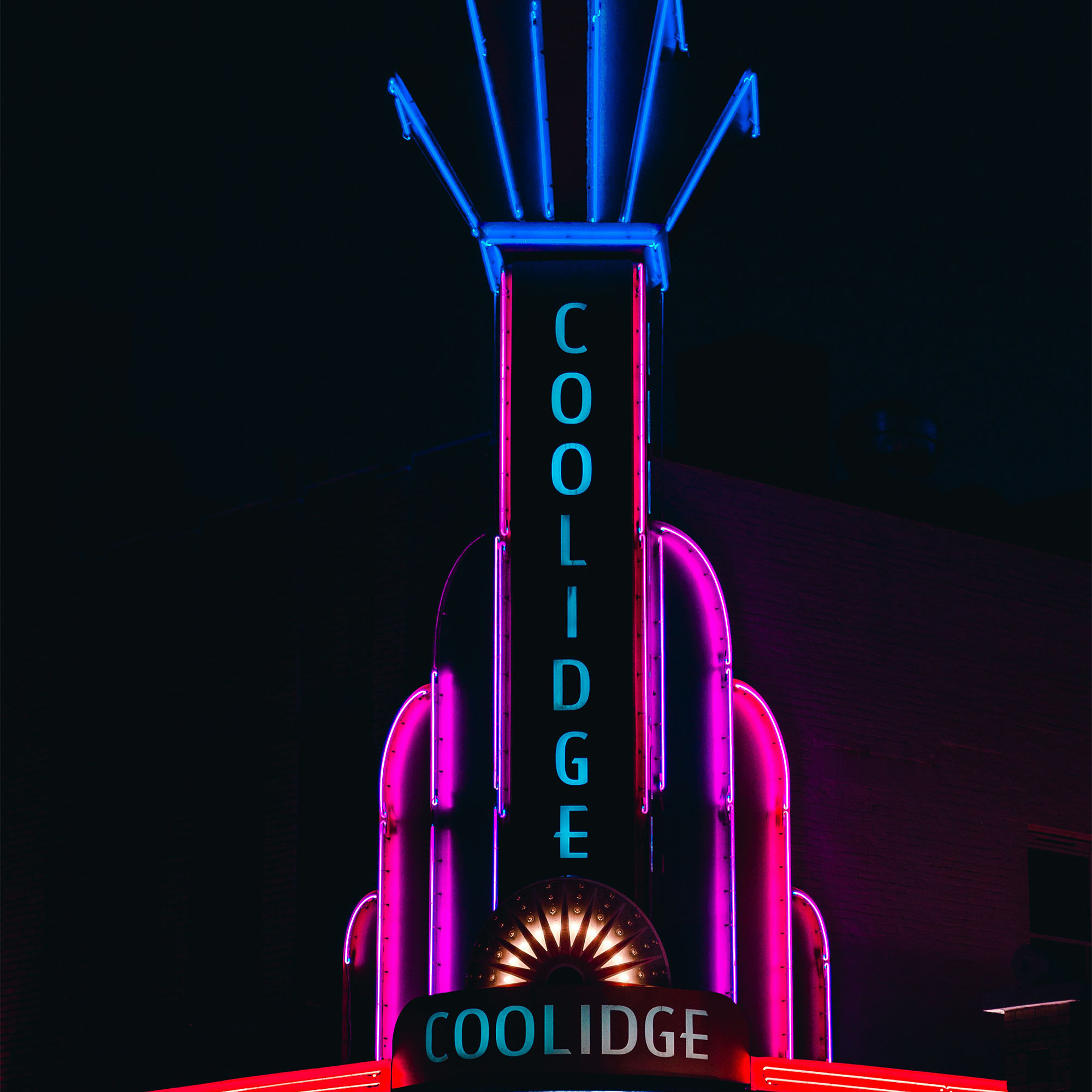 Photo: A neon illuminated sign reading "Coolidge" outside Coolidge Corner theatre in Brookline, MA