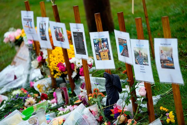 Photo: ain soaked memorials for those who died in a mass shooting sit along the roadside by Schemengees Bar.