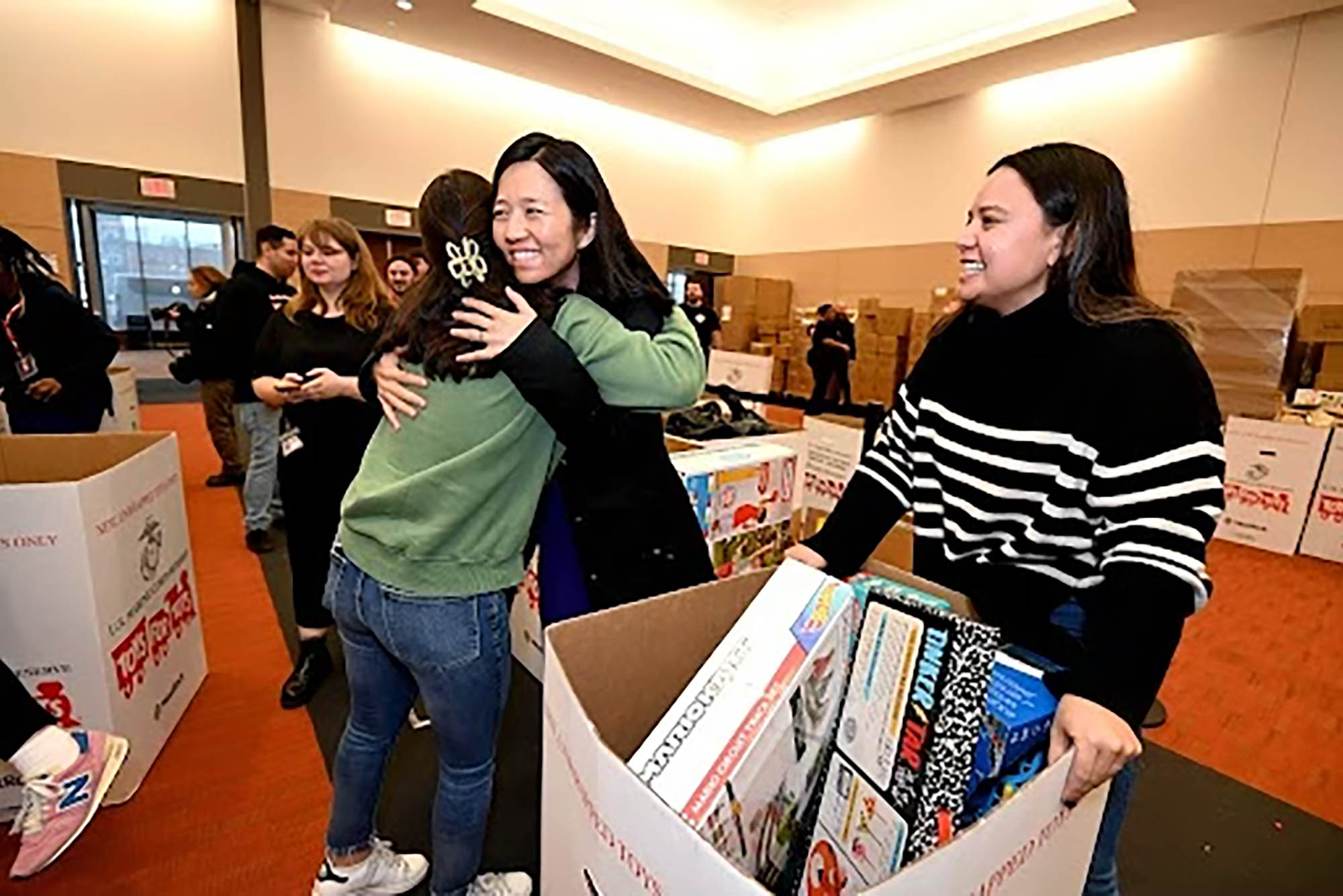 Photo: Mayor Michelle Wu stops by the Toys for Tots to tour the operation and to greet and thank the volunteers and organizers.