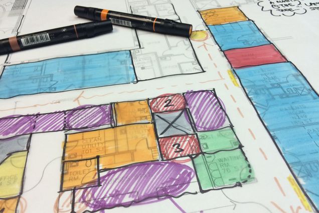 Photo: A colorful sketch of a hospital design with markers laying on top of it