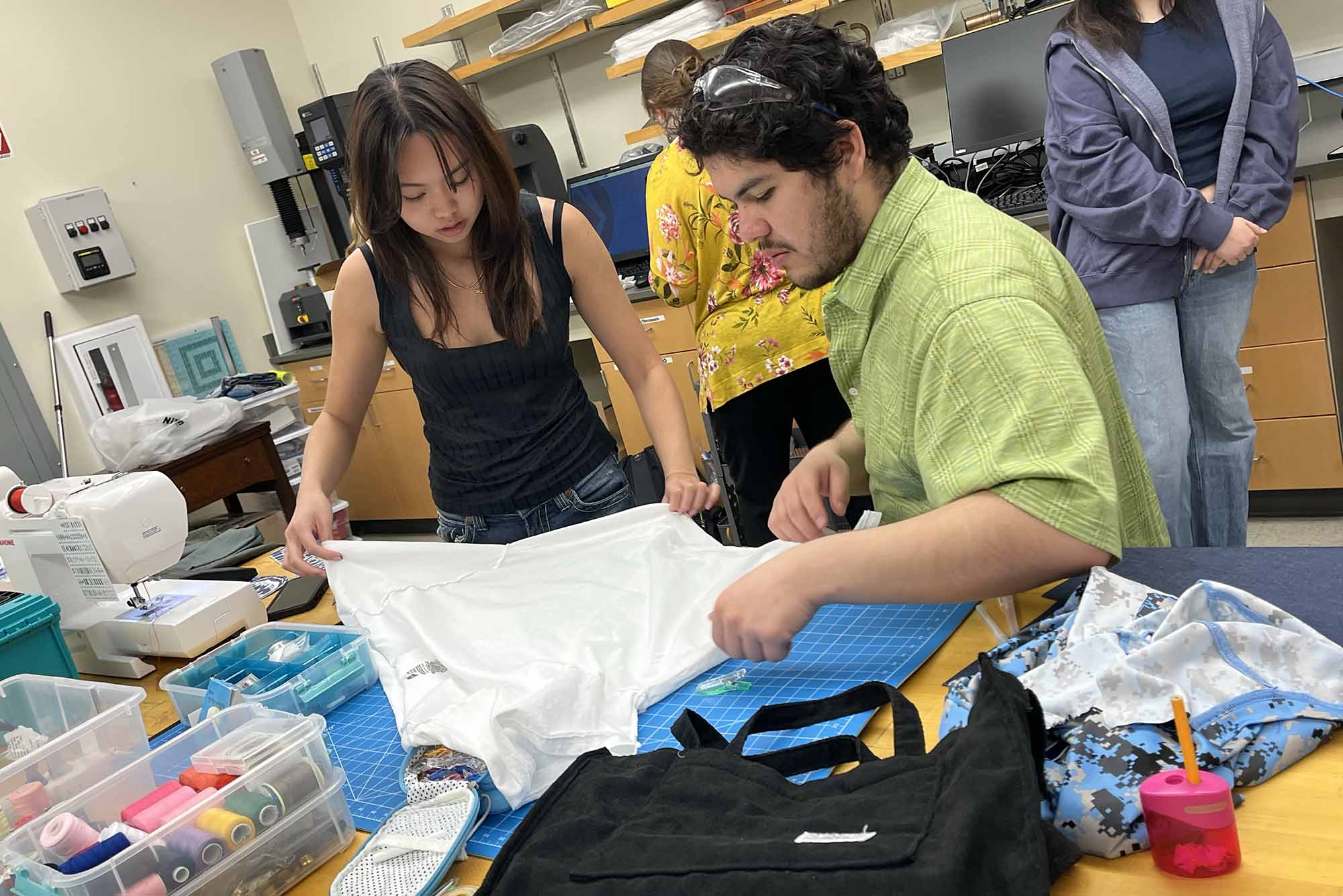 Photo: Shannah Virivong (Questrom’26) (left) and Ivan Perez (CAS’24) transforming a white shirt for their project on US militarism in everyday life.