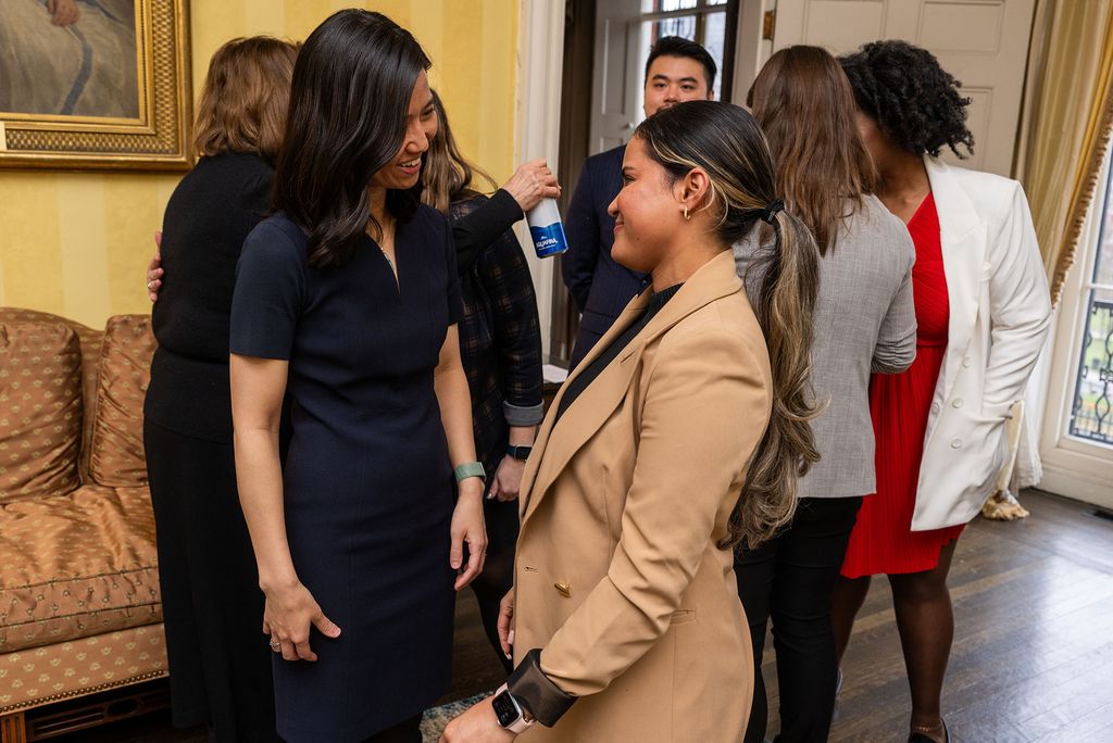 Photo: A picture of two women in business attire having a conversation