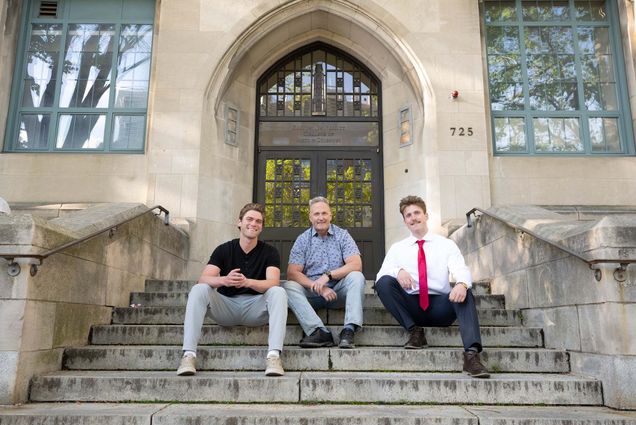 Photo: A picture of a father sitting on the steps with his sons on either side of them. The building behind them says "Boston University College of Arts & Sciences"