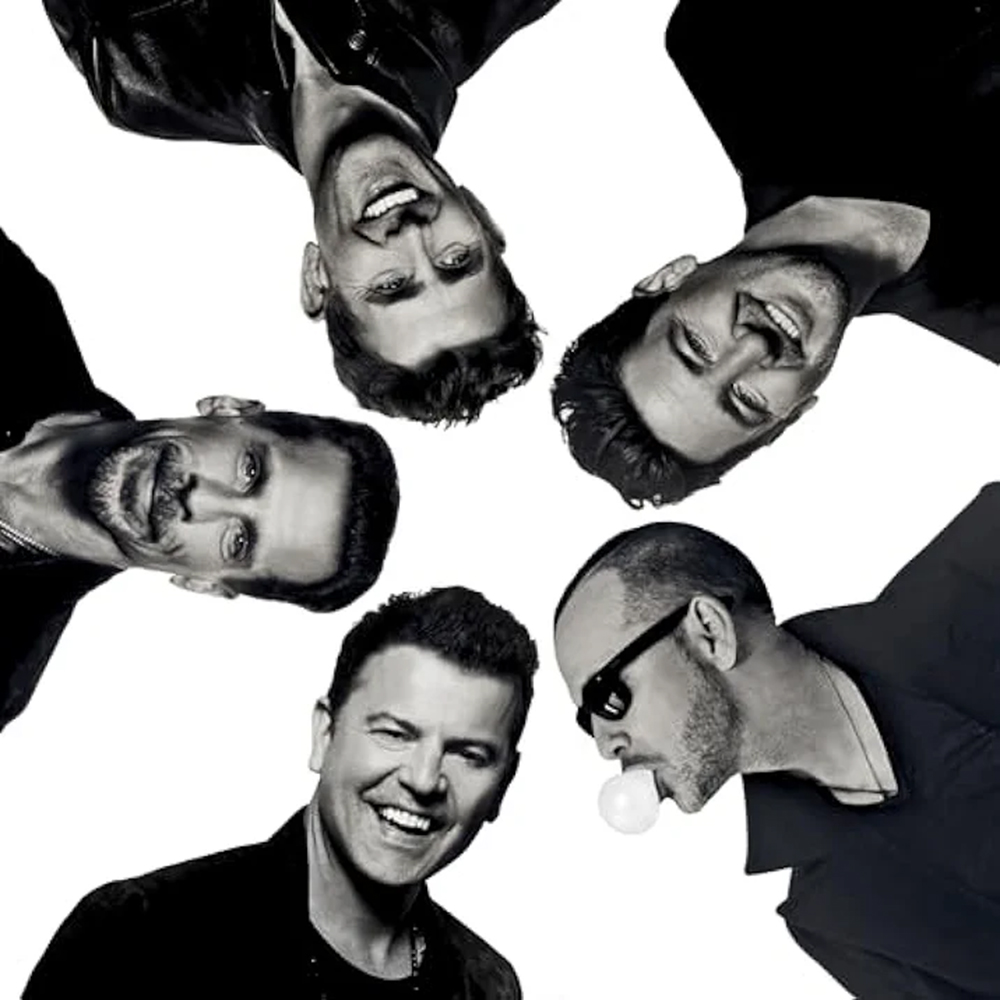 Photo: An album cover of 5 men's heads coming out of various sides of the picture