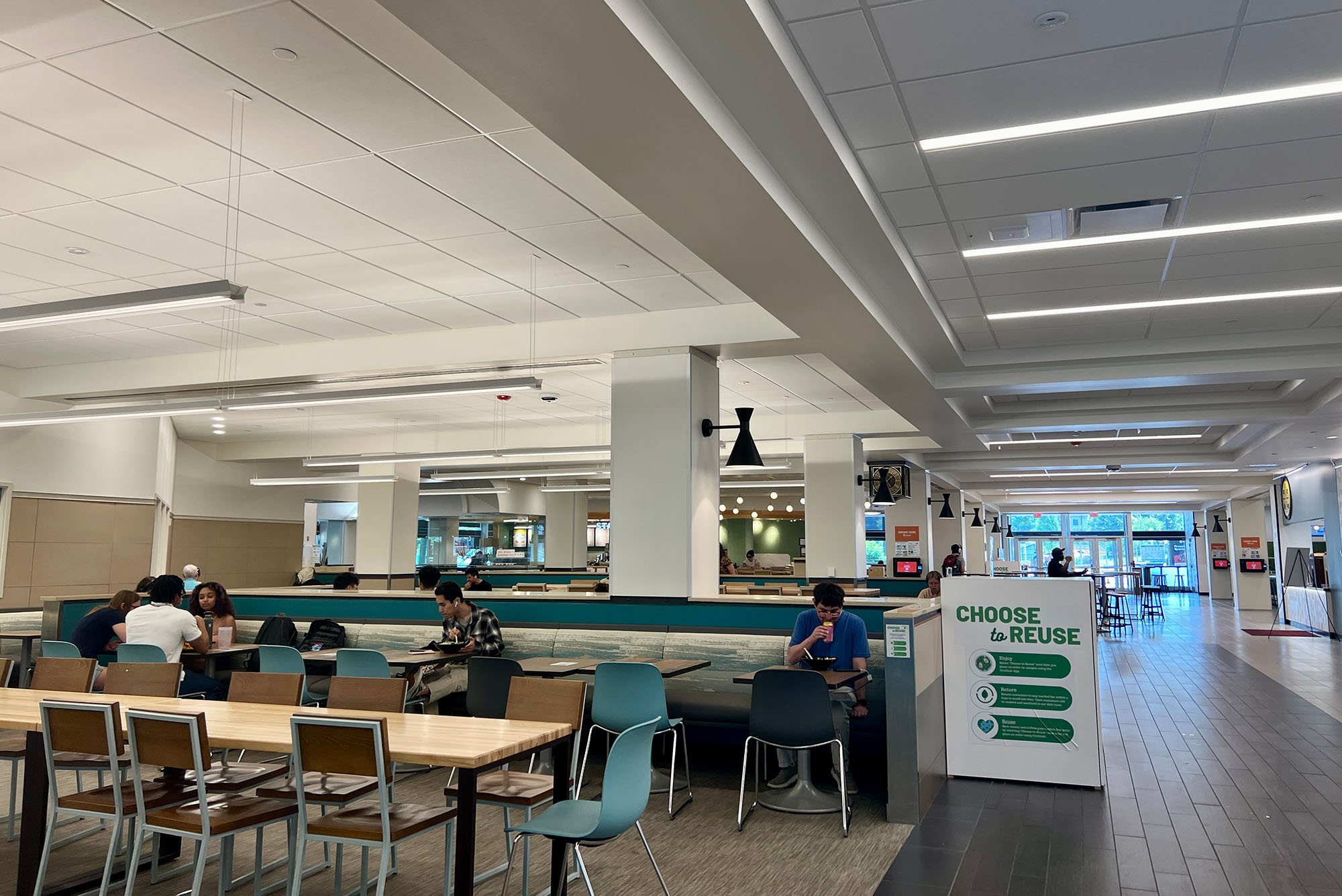 Photo: A picture of the inside of a college academic building with tables and chairs for studying