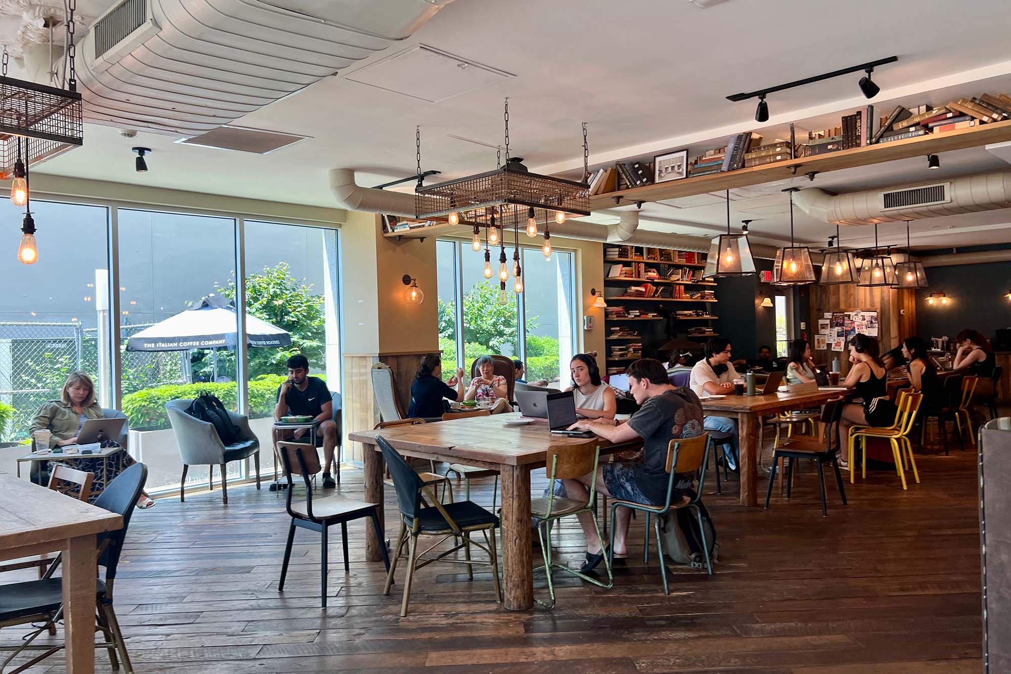 Photo: A picture of the inside of a cafe with people working at the tables