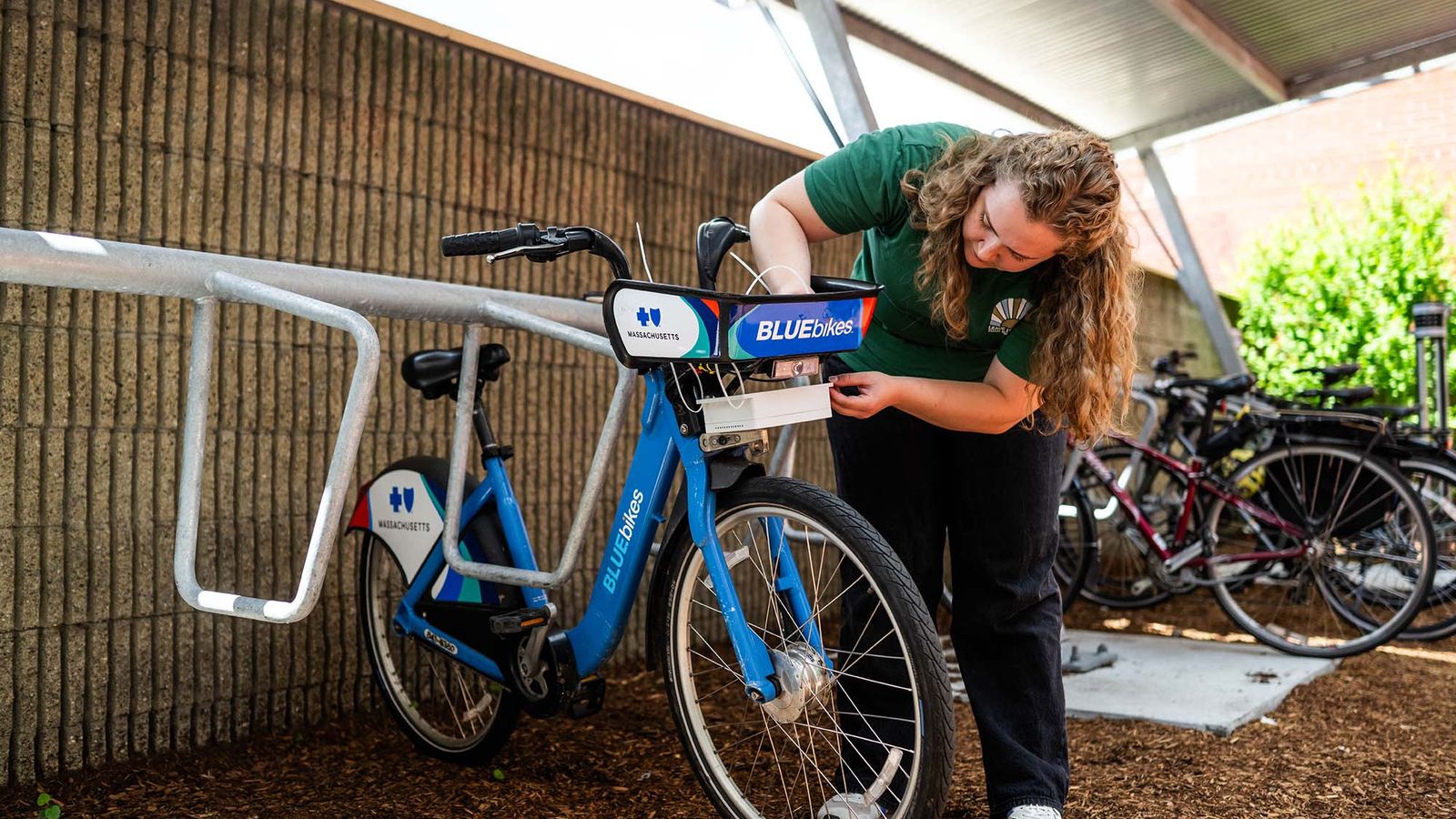 Photo: A woman mounts a sensor on a Boston city Blue Bike.