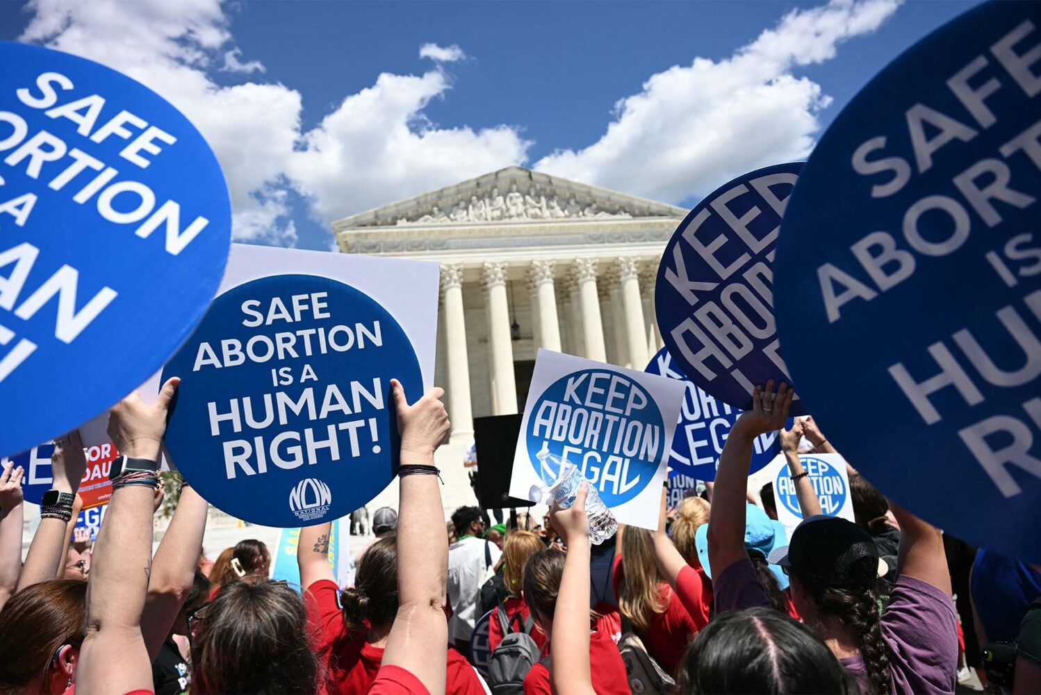 Photo: A sea of protesters holding signs that read "safe abortion is a human right" outside of the US supreme court