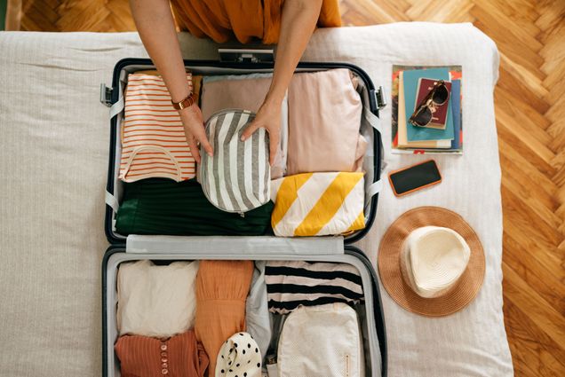 Photo: A picture of someone packing and organizing a suitcase for vacation