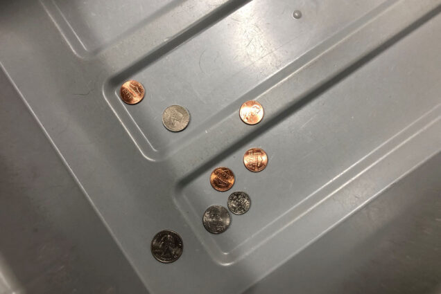 Photo: A picture of a TSA bin with loose change in it