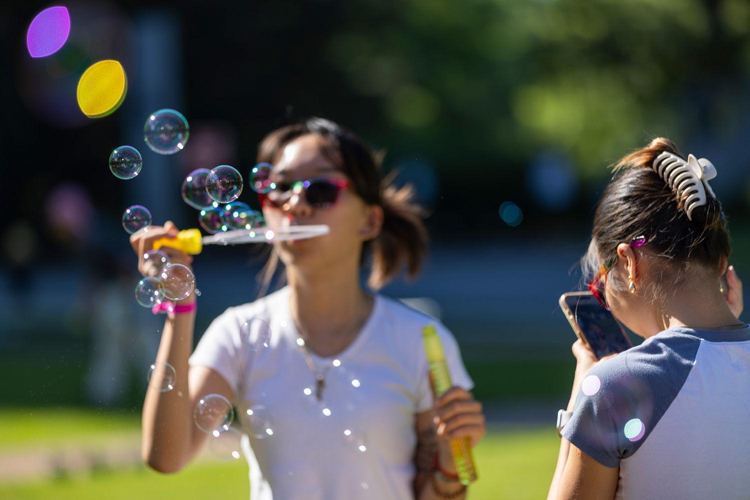 Photo: A picture of a woman blowing bubbles