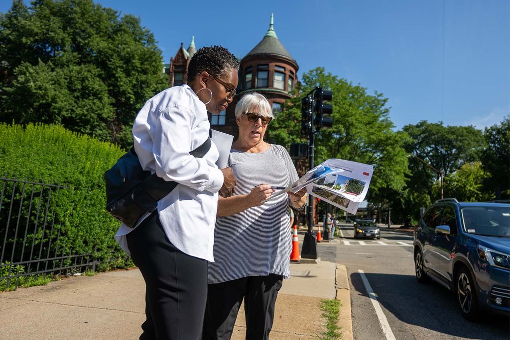 Photo: Two women inspect a map on a sunny day in Boston, MA