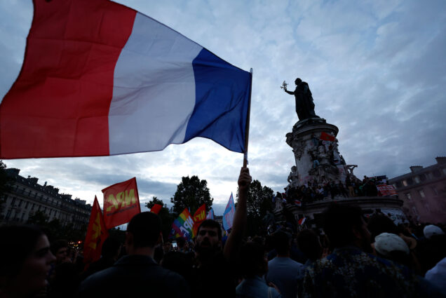 Photo: A picture of the Republique Plaza in Paris with a large French flag waving