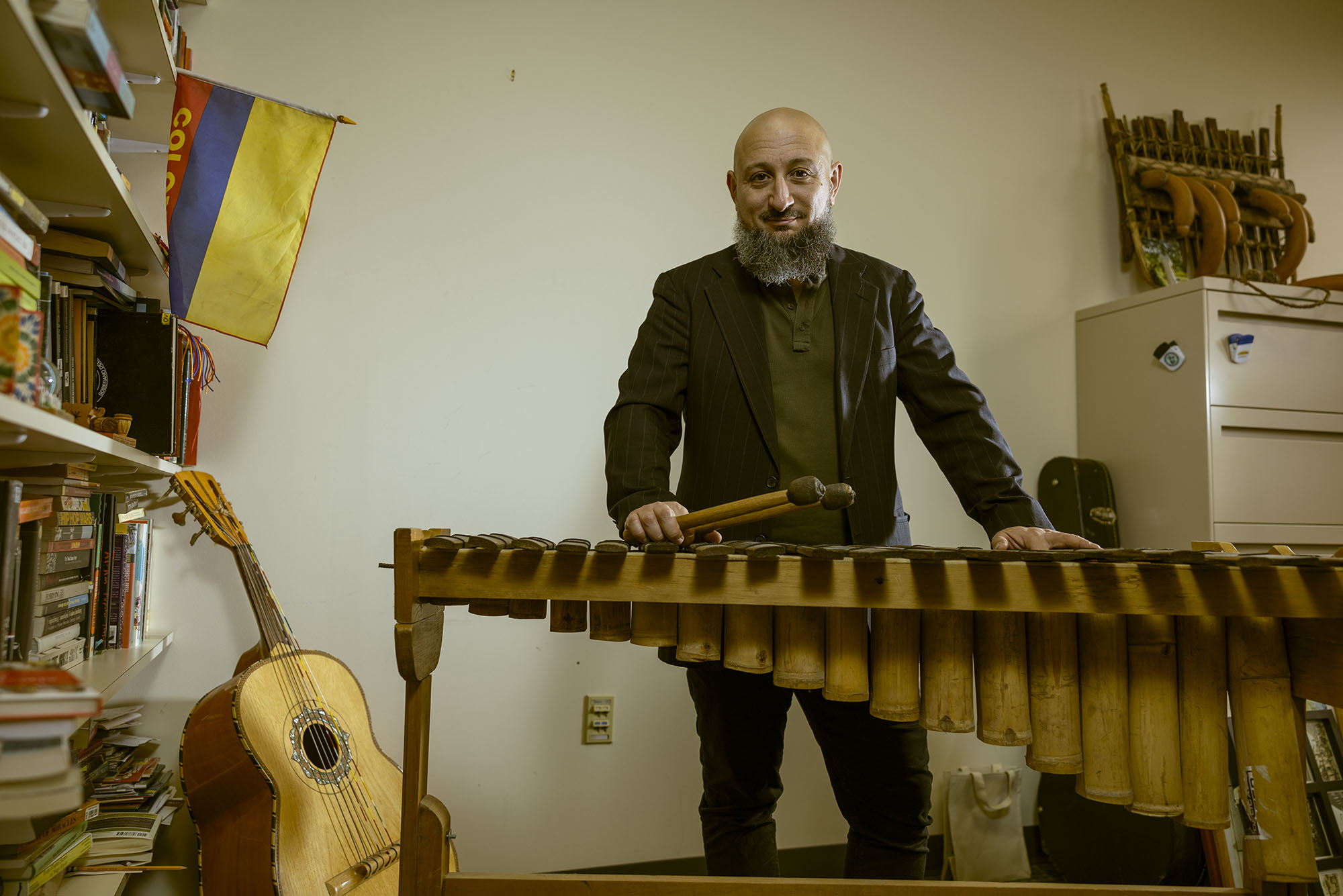 Photo: A wide shot of Prof. Michael Quintero playing on a xylophone