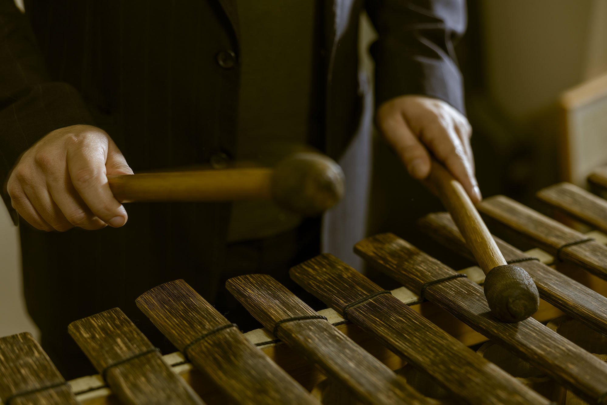 Photo: A closeup shot of Prof. Michael Quintero playing on a xylophone