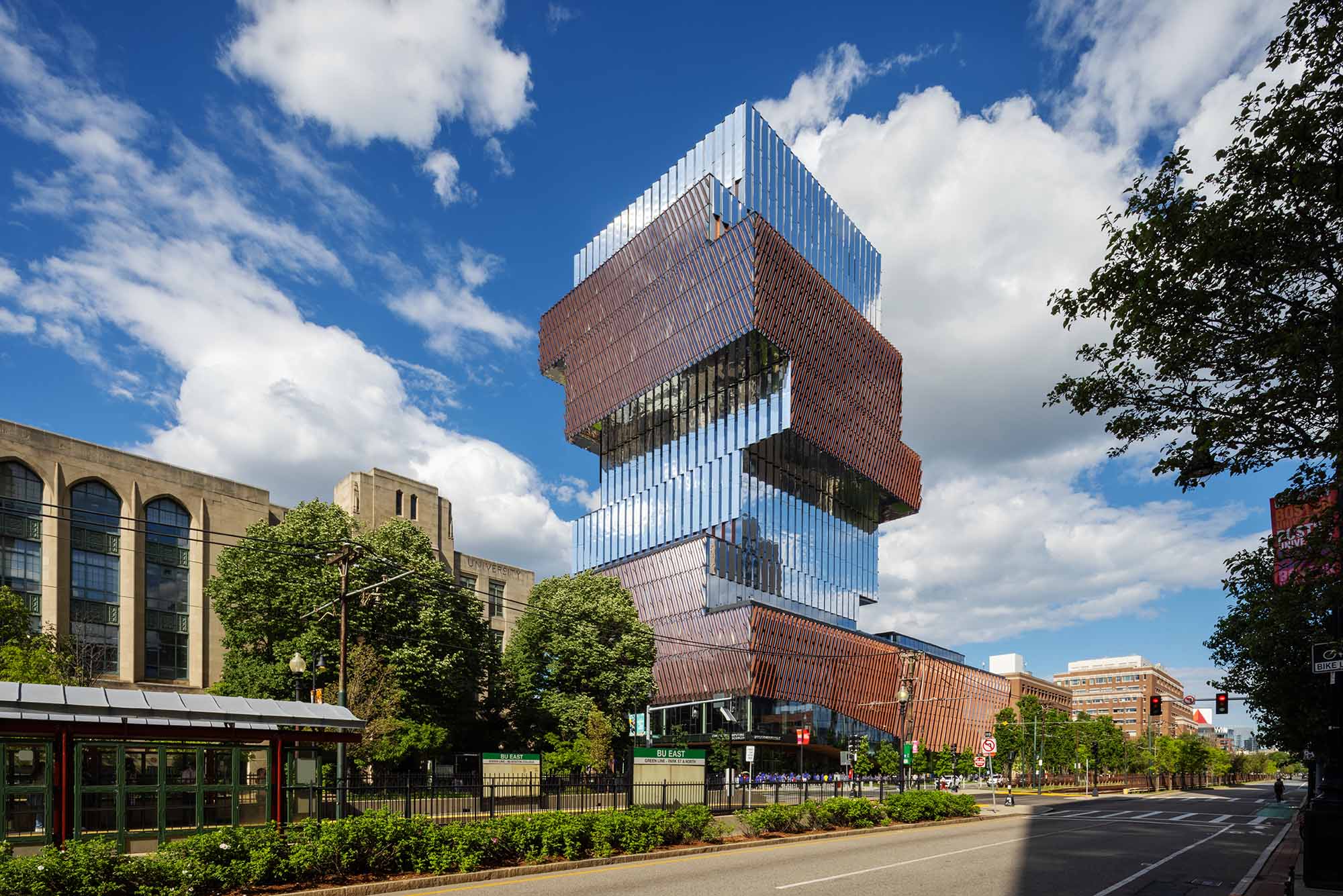 Photo: Exterior shot of BU's Center for Data Sciences, a jenga shaped glass building that stands tall in the Boston Skyline on a sunny day as cars drive by on Commonwealth ave