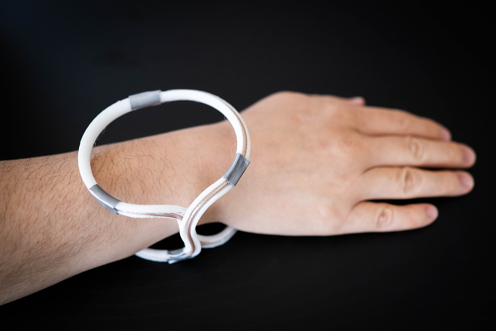 Photo: Photo: A highly compact and lightweight coil specifically designed to enhance MRI finger imaging wirelessly, the device is wrapped around a wrist.