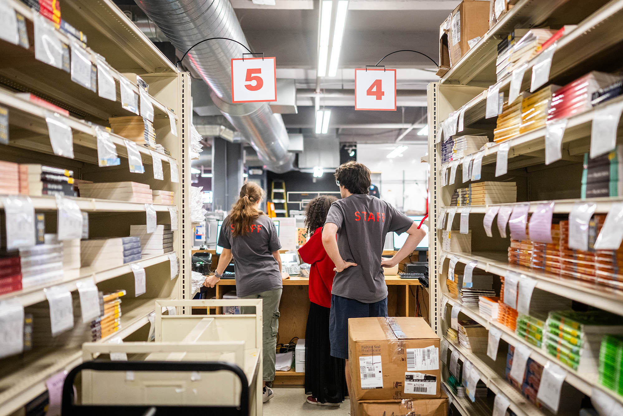 Photo: Students help sort textbooks in the BU Campus Store.